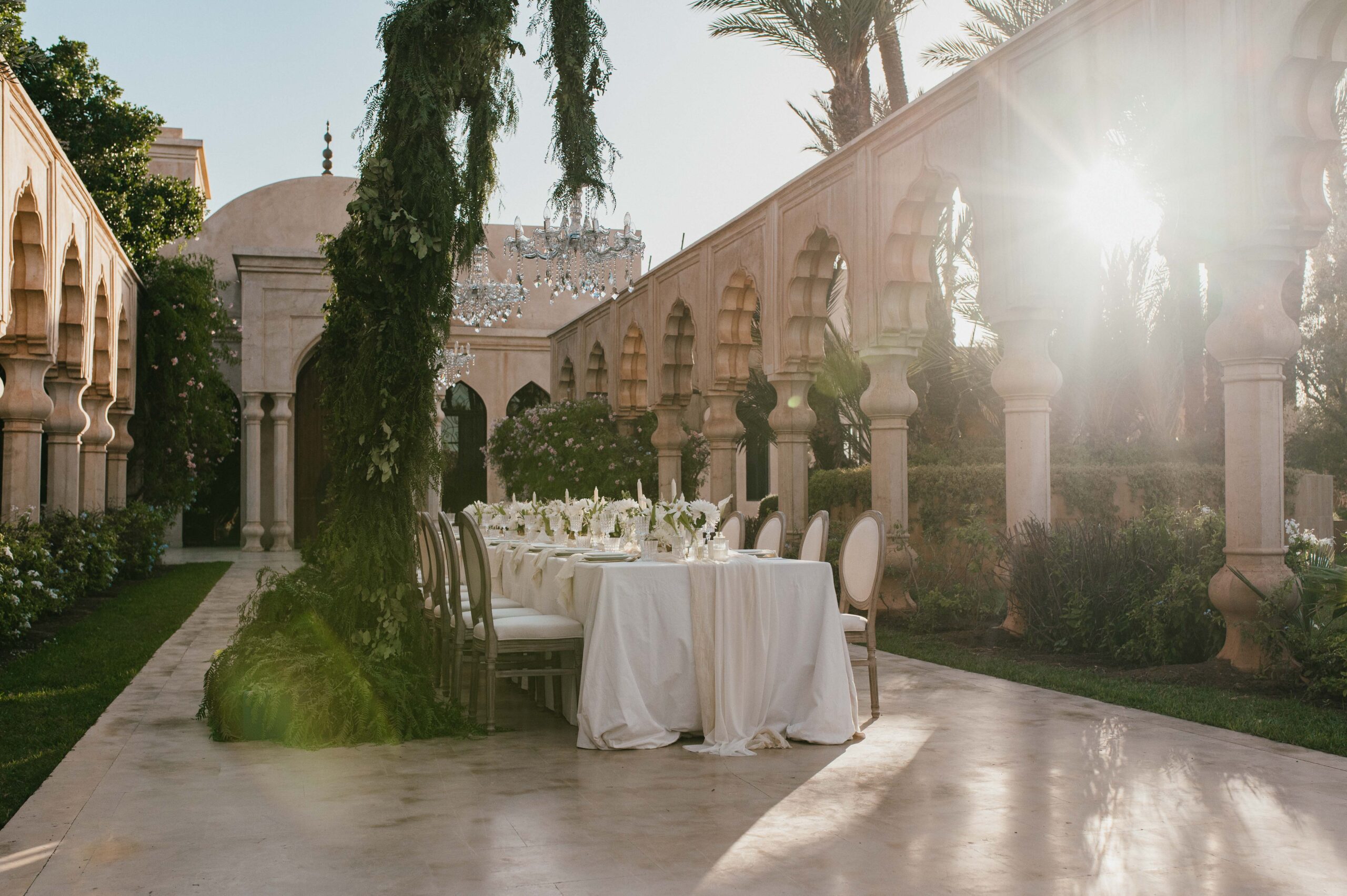 Luxurious wedding table decor with chandeliers at Palais Namaskar. 