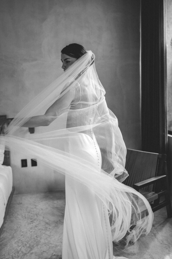 Bride dancing with her veil wearing le blanc bridal by casablanca. 