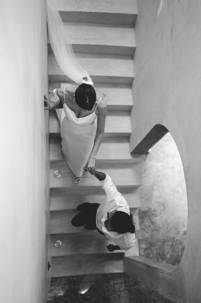 Aerial black and white photo of couple in staircase vogue style. 