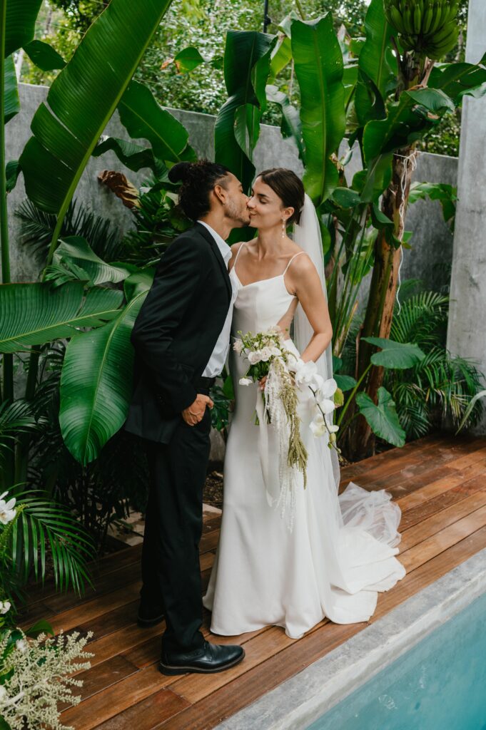 Romantic photography of bride and groom kissing at their tulum villa elopement. 