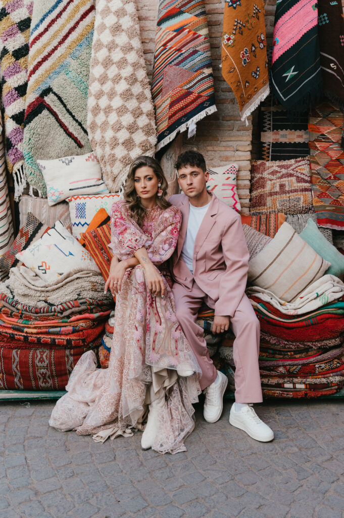 Bride and groom sitting on Moroccan carpets in the Medina. 
