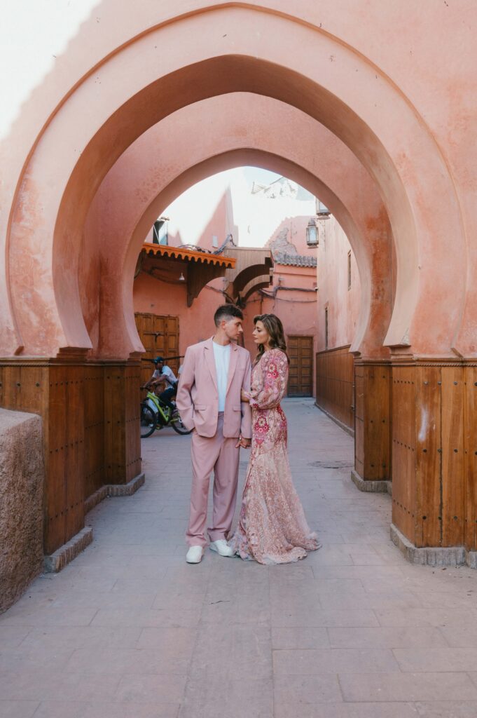 Lisa, wearing rue de seine gown, holding hands with Paul after their Marrakech elopement. 