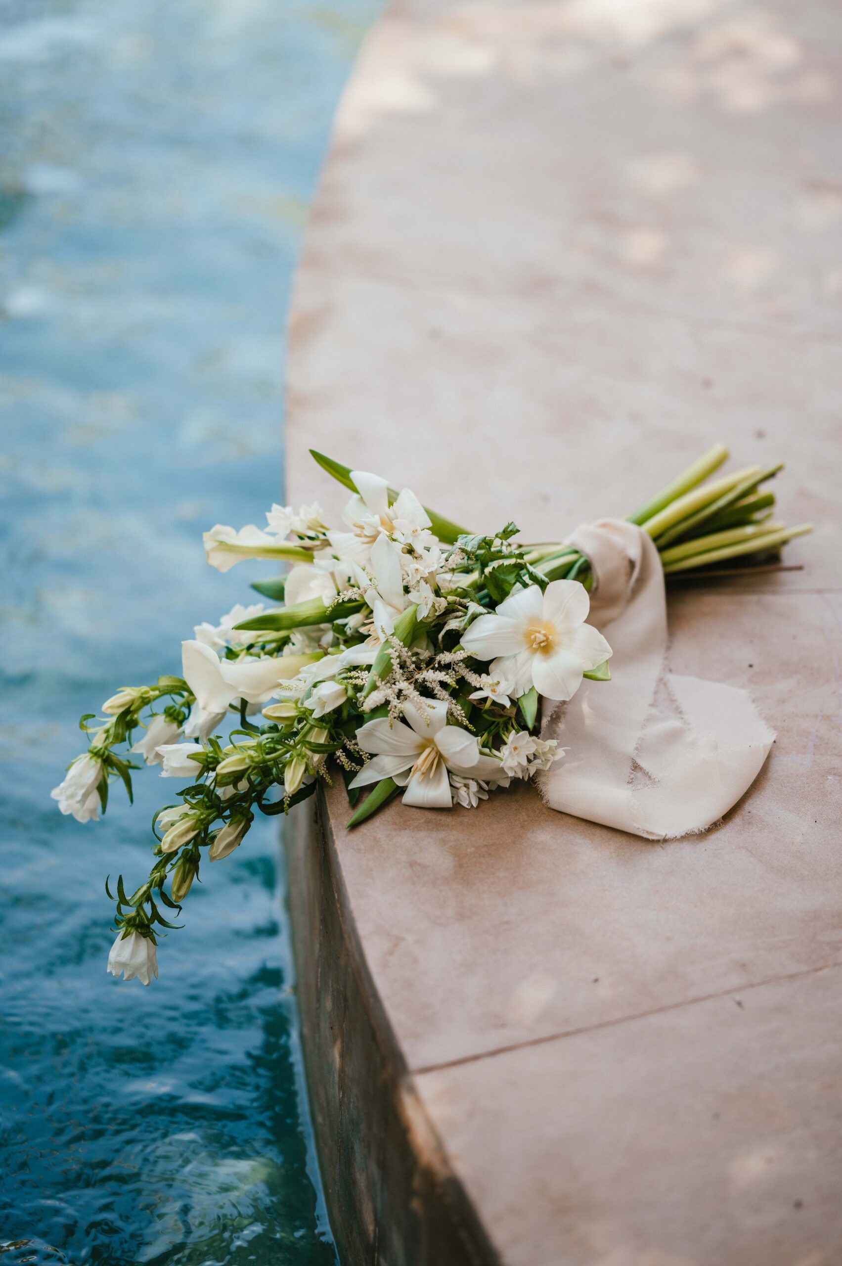 Bridal bouquet by water. 