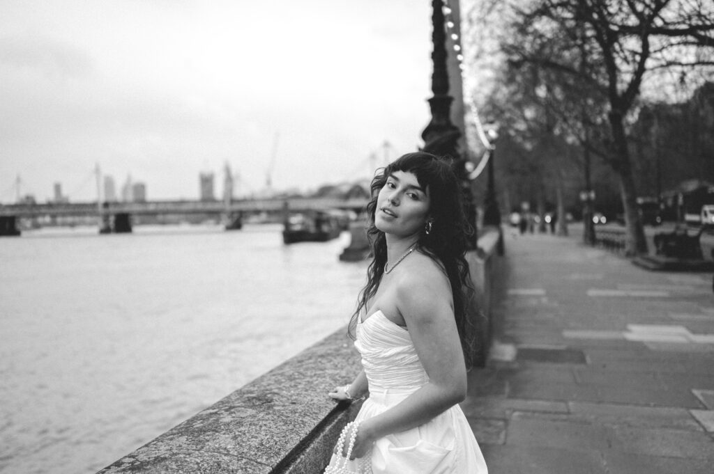 Close up of bride Mag by Thames River with Big Ben and London Eye in the background.
