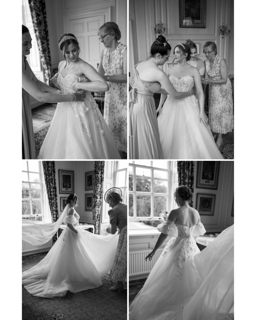 A series of candid black-and-white wedding photos capturing intimate bridal preparation moments at Amanda and John’s wedding at Kingston Bagpuize House. The images showcase the bride getting ready with the help of her bridesmaids and mother, adjusting her gown and veil in a bright, elegant room with large windows and classic decor. The bride exudes grace and excitement as her family surrounds her with care and attention, highlighting the emotional and tender moments of the morning.