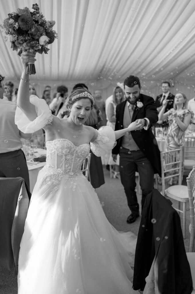 Amanda and John making their grand entrance in the reception room before their wedding breakfast.