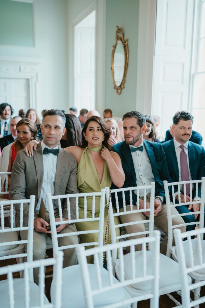 Guests eagerly awaiting the bride's entrance before the wedding ceremony at Botleys Mansion in Surrey.