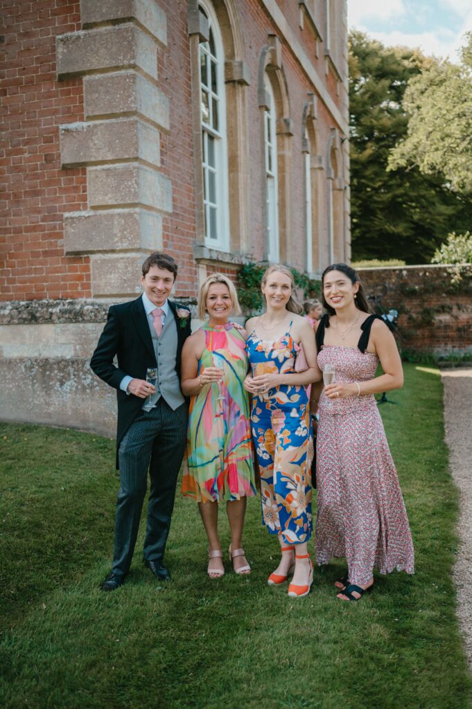 Guests enjoying the vibrant reception at Kingston Bagpuize House, with colourful decor and joyful energy.