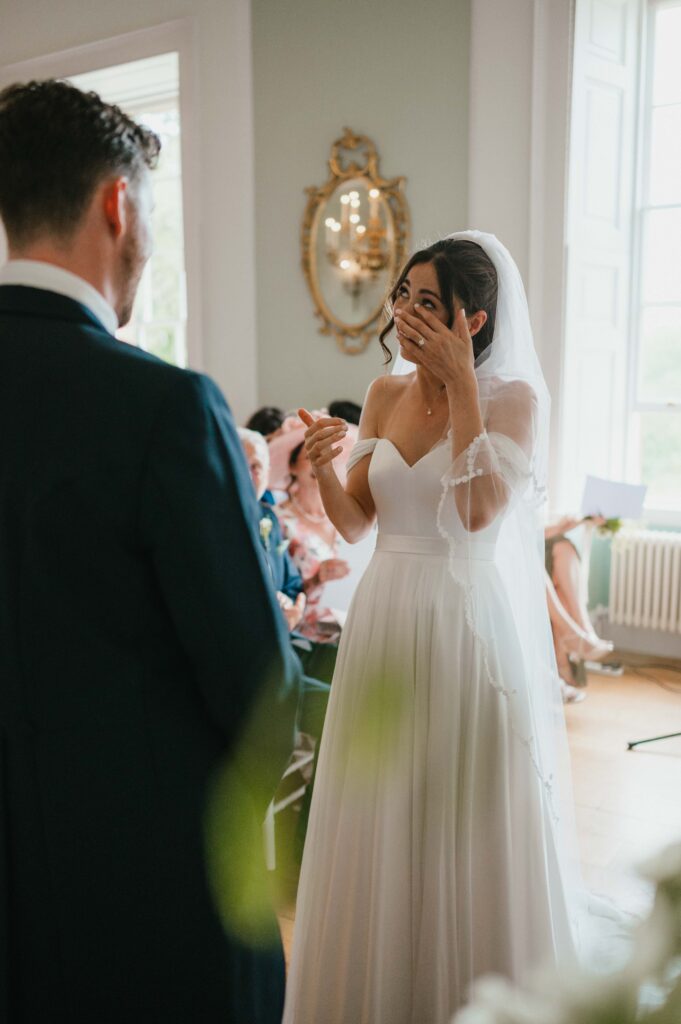 The bride, Charlie, wiping away a tear as Martin read his vows.