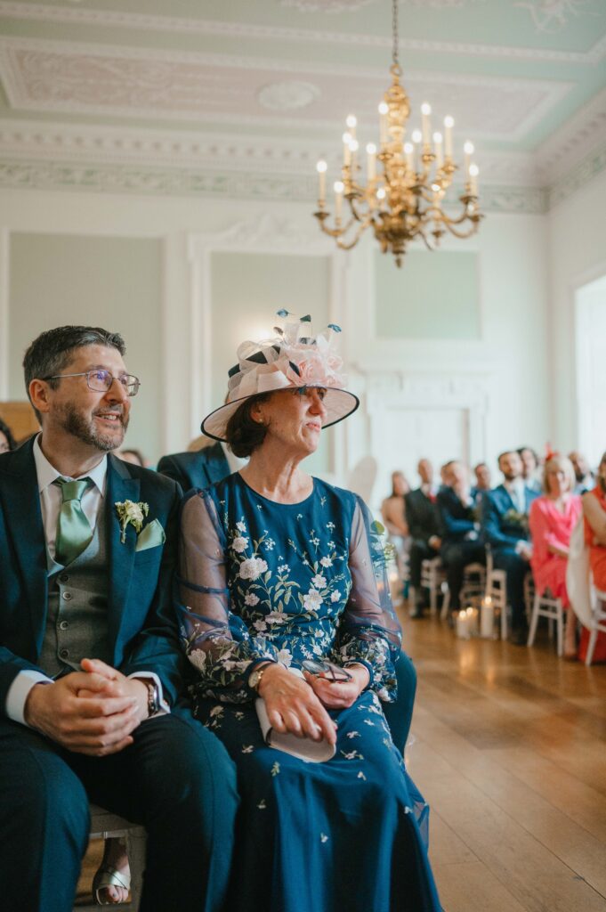 Portrait of the father of the bride and the mother of the bride watching the ceremony in tears in their eyes.