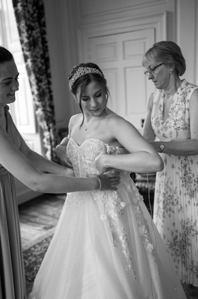 A candid shot of Amanda in her wedding dress, beaming with excitement and anticipation for the wedding ceremony ahead.