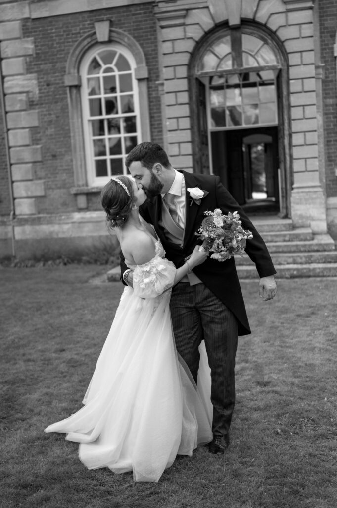 A striking black and white close-up of Amanda and John sharing a kiss, showcasing their love and connection with an intimate, timeless feel.