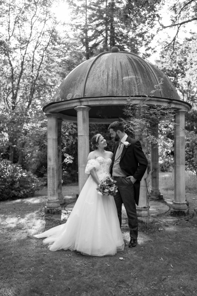 A romantic black and white portrait of Amanda and John, bathed in soft lighting that captures their deep connection and love.