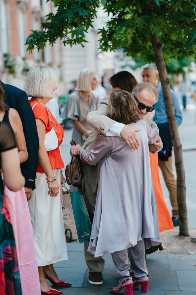 Father of the bride embracing an aunt. 