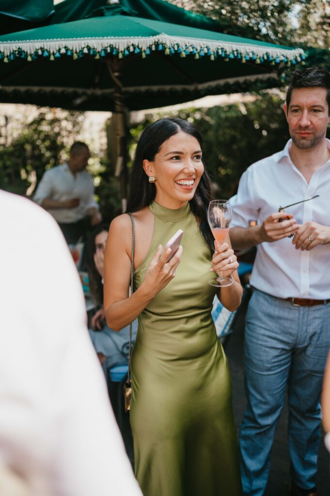 Guests enjoy delicious canapés and cocktails at The Ivy, engaged in lively conversations as they toast to the newlyweds after their Chelsea Old Town Hall wedding ceremony.