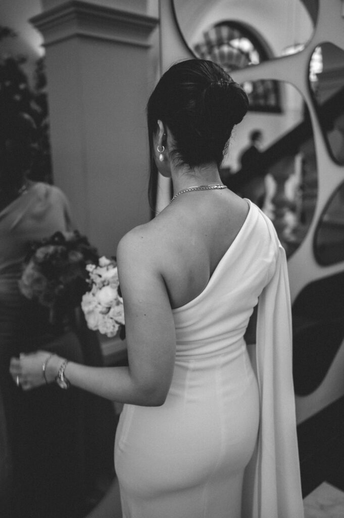 Raissa standing in the foyer of Chelsea Old Town Hall wedding. 