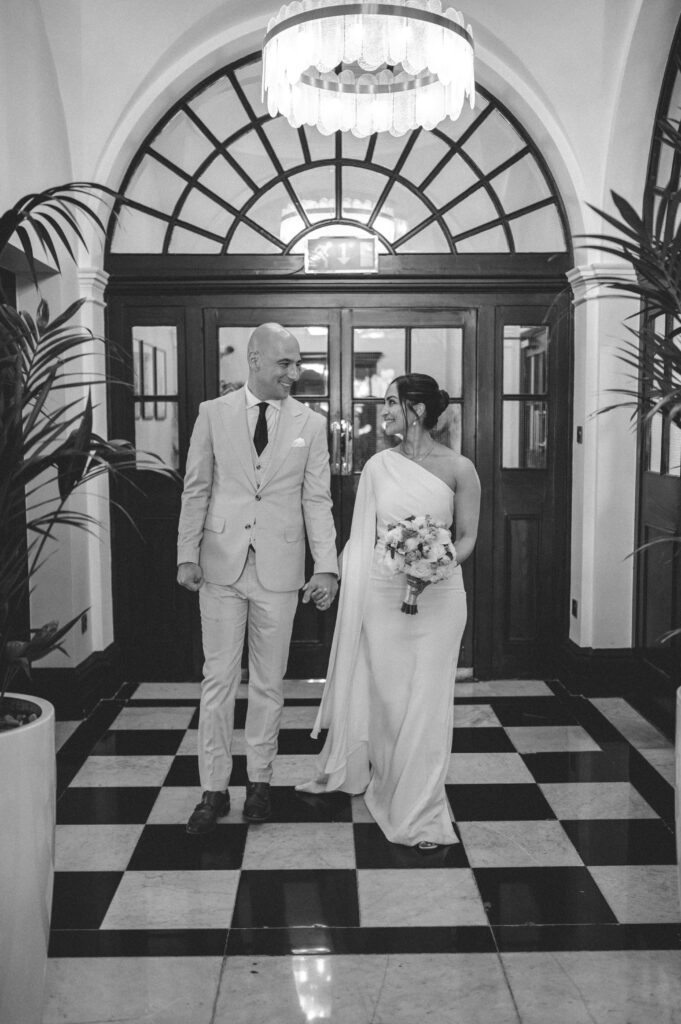 Raissa and Vasileios embracing after their Chelsea old town hall wedding ceremony.