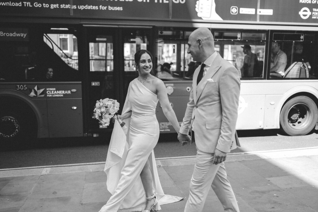 Raissa and Vasileios make their way through London's streets, hand-in-hand, after their beautiful Chelsea Old Town Hall wedding, on their way to The Ivy for the evening festivities.